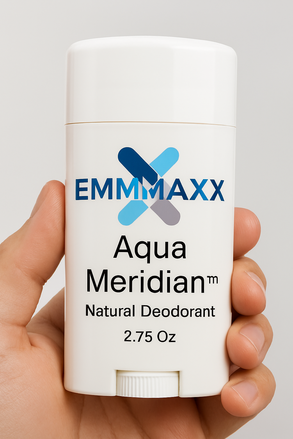Hand holding a white deodorant stick labeled 'EMMMAXX Aqua Meridian Natural Deodorant' on a light gray background